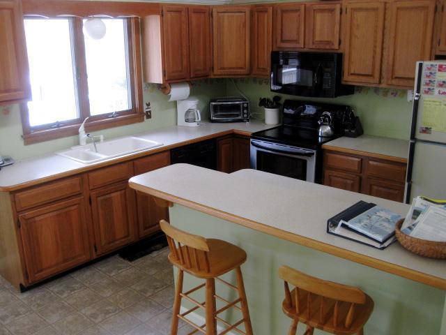 380 Governor Prence Road Eastham, MA 02642 - Photo 17 of 28 a kitchen with stainless steel appliances a stove a sink and a microwave