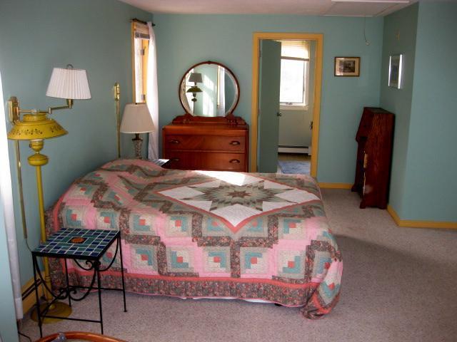 380 Governor Prence Road Eastham, MA 02642 - Photo 18 of 28 a bedroom with a bed a mirror on desk and a dresser