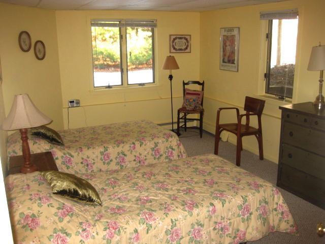 380 Governor Prence Road Eastham, MA 02642 - Photo 21 of 28 a bedroom with a bed and a dresser next to a window
