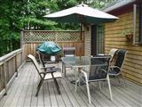 380 Governor Prence Road Eastham, MA 02642 - Photo 4 of 28 a view of deck with table and chairs under an umbrella with wooden floor