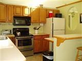 380 Governor Prence Road Eastham, MA 02642 - Photo 8 of 28 a kitchen with a stove and a microwave
