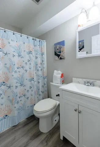 a white toilet sitting next to a bathroom sink
