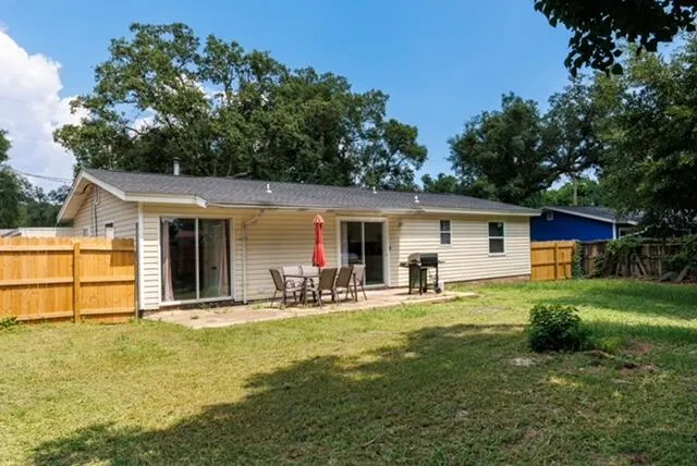 a front view of house with a garden and patio