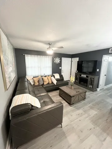 a living room with furniture and a large window