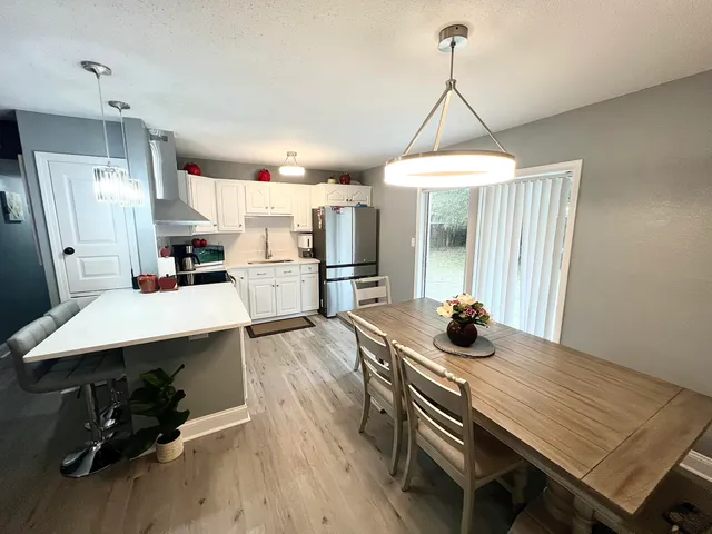 a view of a dining room with furniture window and wooden floor