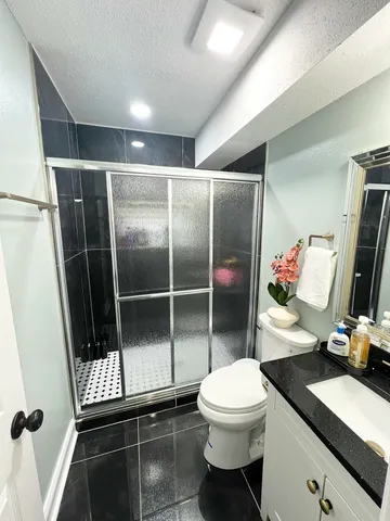 a bathroom with a sink toilet and shower