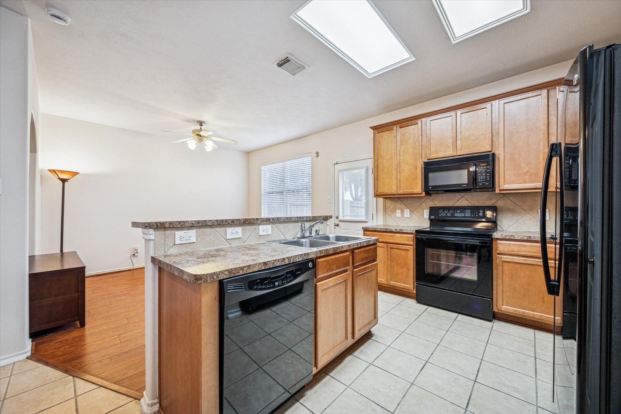 3206 Pearl Bluff Lane Houston, TX 77047 - Photo 6 of 20 a kitchen with granite countertop a stove top oven and cabinets