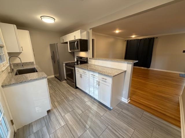 1219 South White Station Road Memphis, TN 38117 - Photo 6 of 18 a kitchen with a sink wooden floor and stainless steel appliances