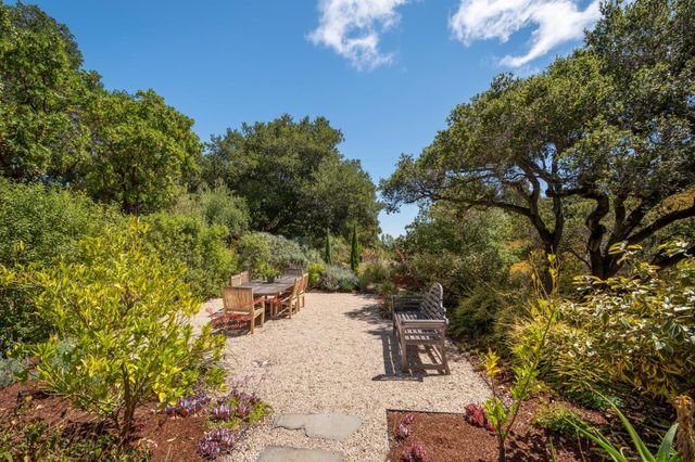 a view of a backyard with sitting area