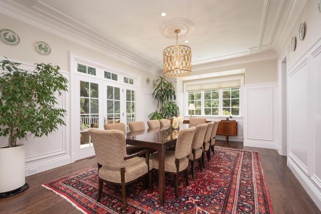 a view of a dining room with furniture wooden floor and chandelier
