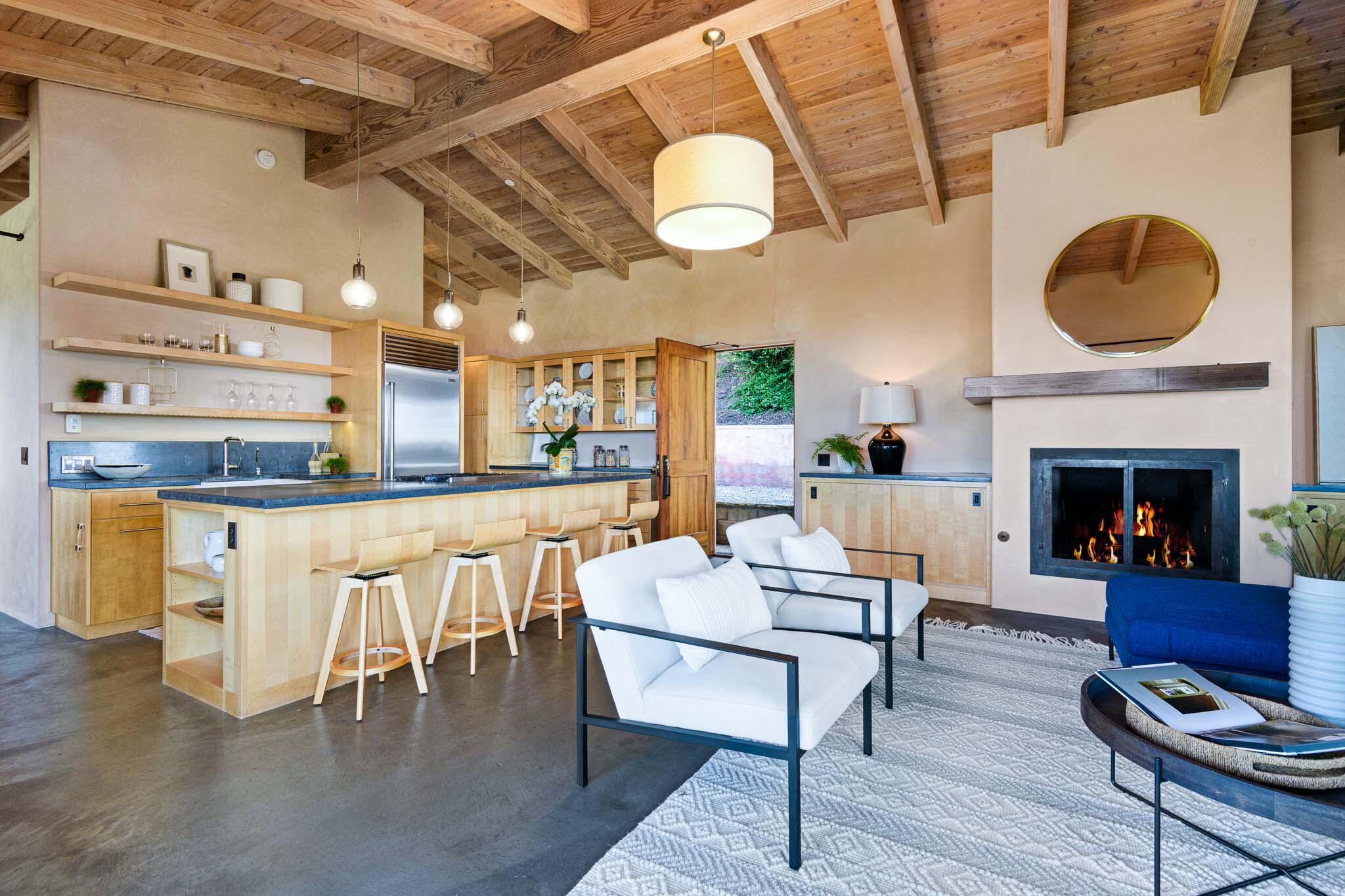 356 East Mountain Drive Montecito, CA 93108 - Photo 2 of 36 a dining room with furniture a fireplace and wooden floor