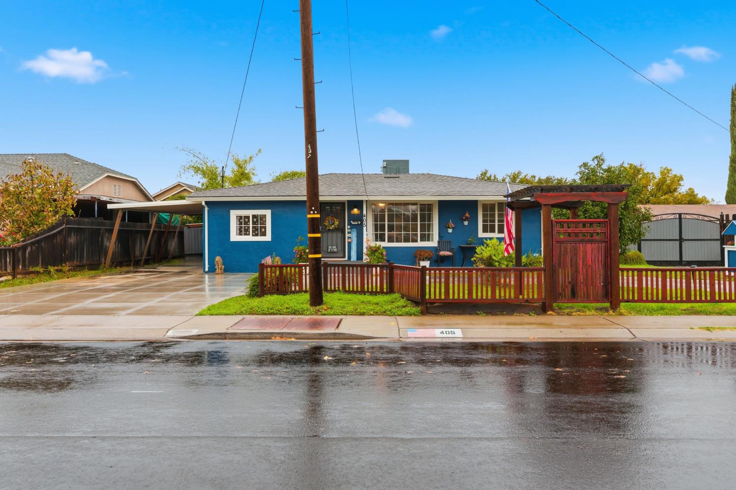 a view of a building with a yard and potted plants