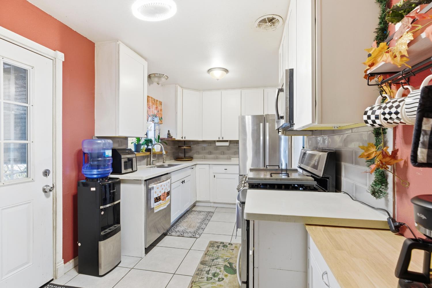 405 East Edison Street Manteca, CA 95336 - Photo 13 of 38 a kitchen with a refrigerator and a stove
