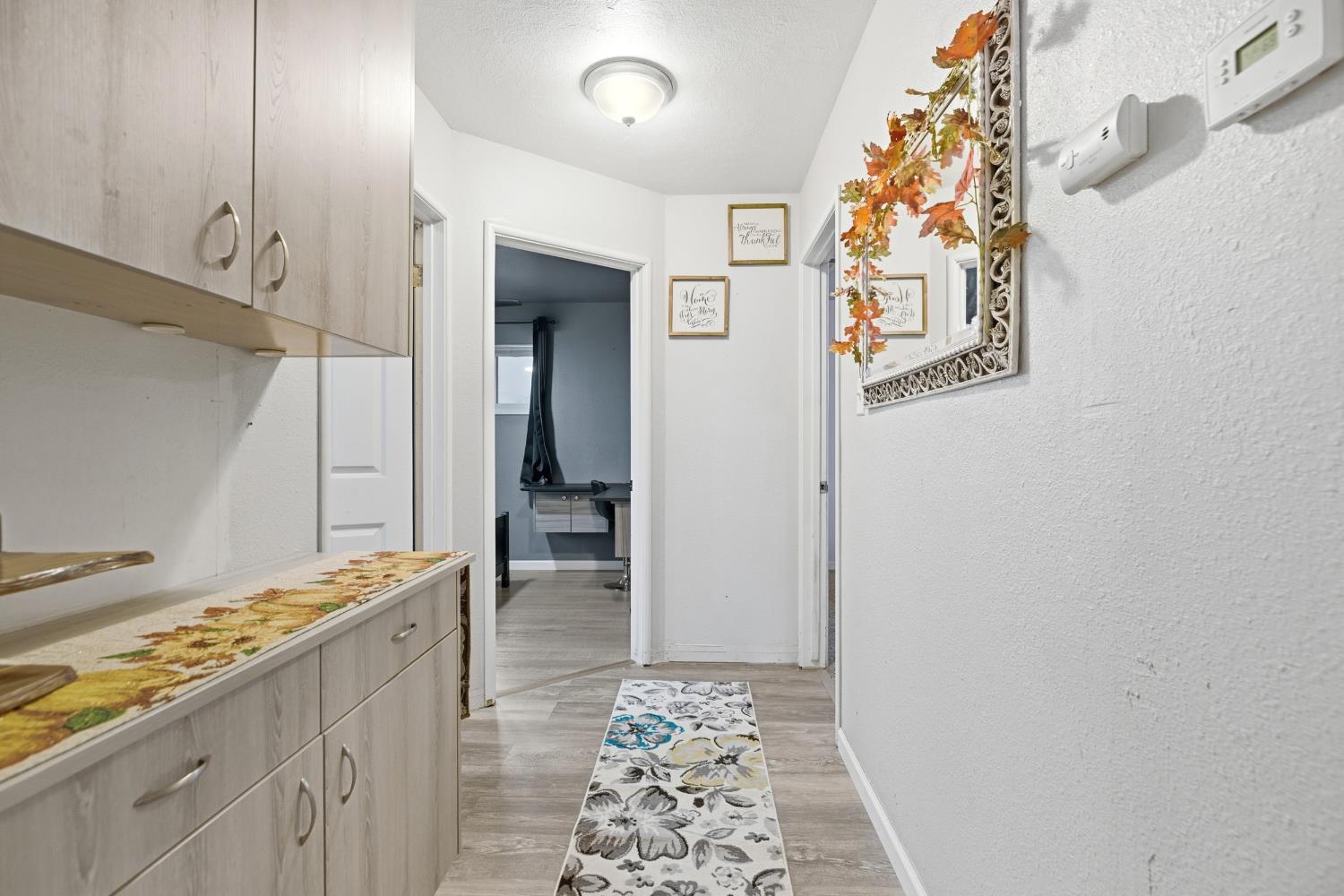 405 East Edison Street Manteca, CA 95336 - Photo 16 of 38 a hallway with dining area and chandelier