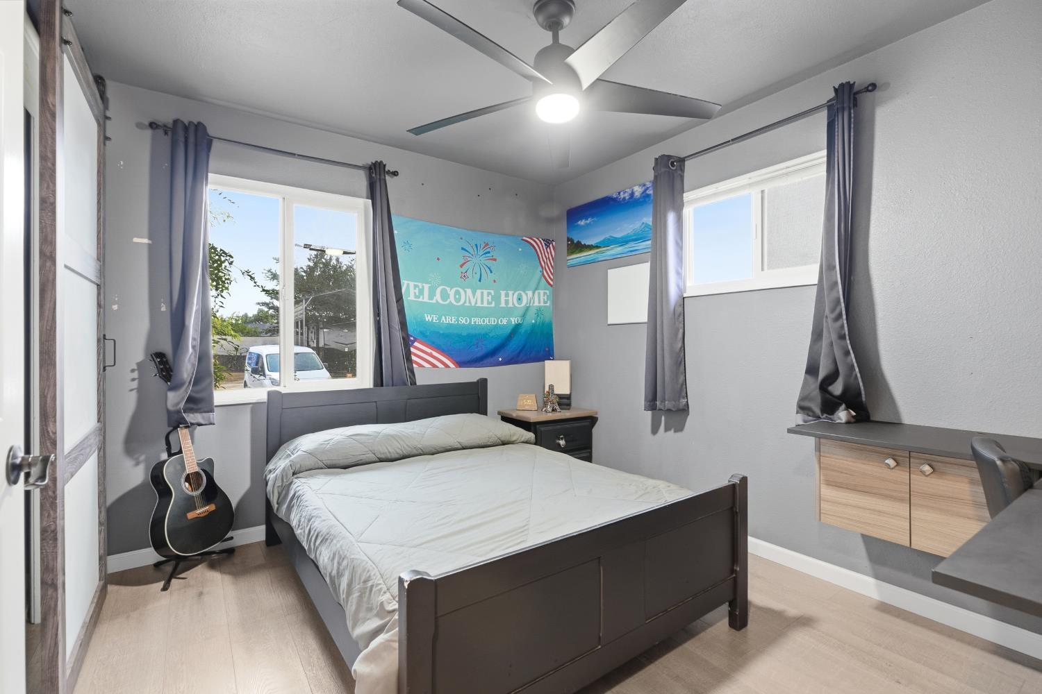 405 East Edison Street Manteca, CA 95336 - Photo 17 of 38 a bedroom with a large bed and a chandelier