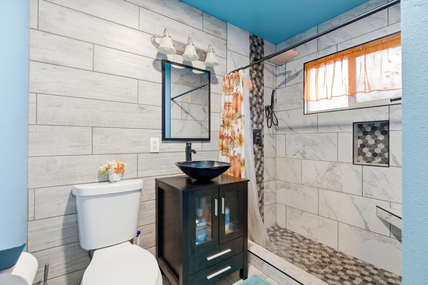 405 East Edison Street Manteca, CA 95336 - Photo 19 of 38 a bathroom with a sink toilet and shower