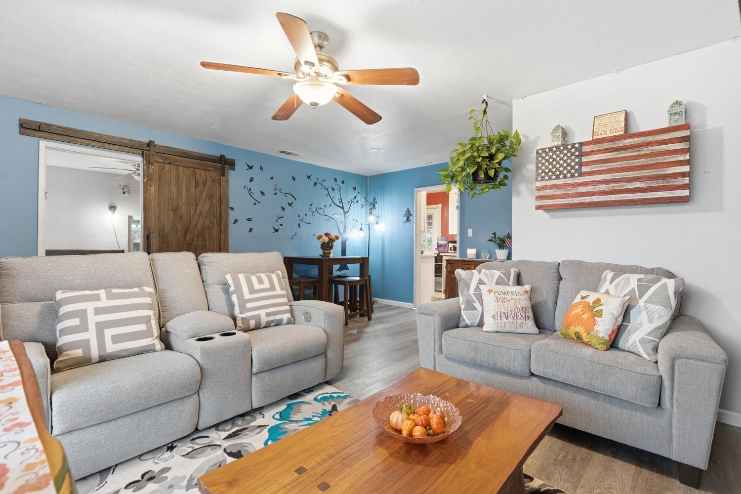 405 East Edison Street Manteca, CA 95336 - Photo 7 of 38 a living room with furniture kitchen view and a chandelier