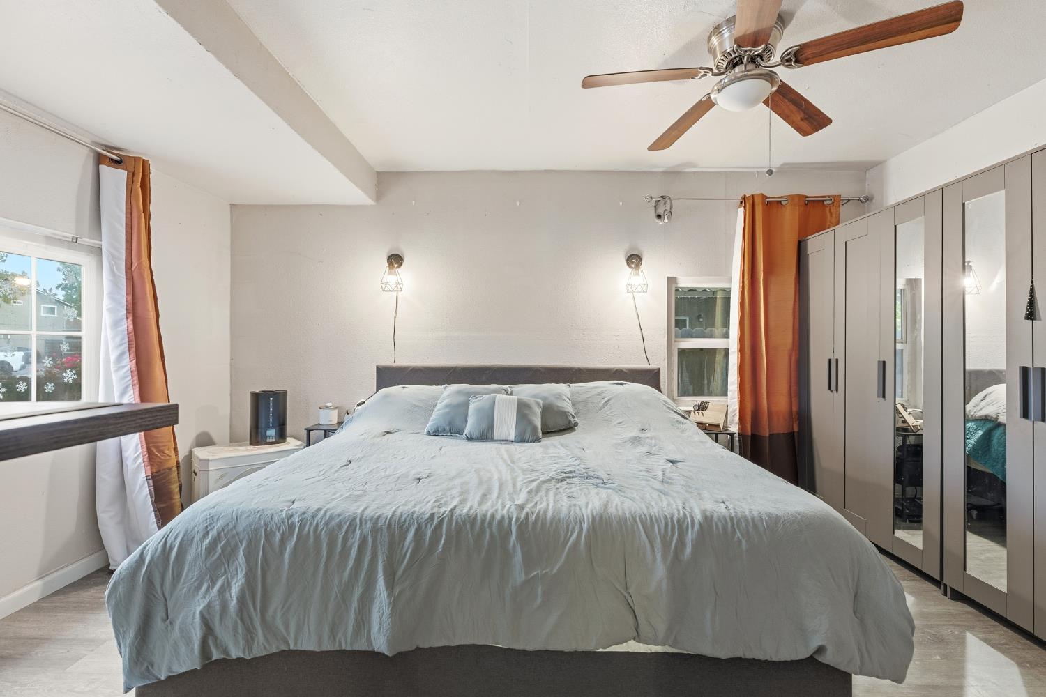 405 East Edison Street Manteca, CA 95336 - Photo 10 of 38 a bedroom with a large bed and a chandelier