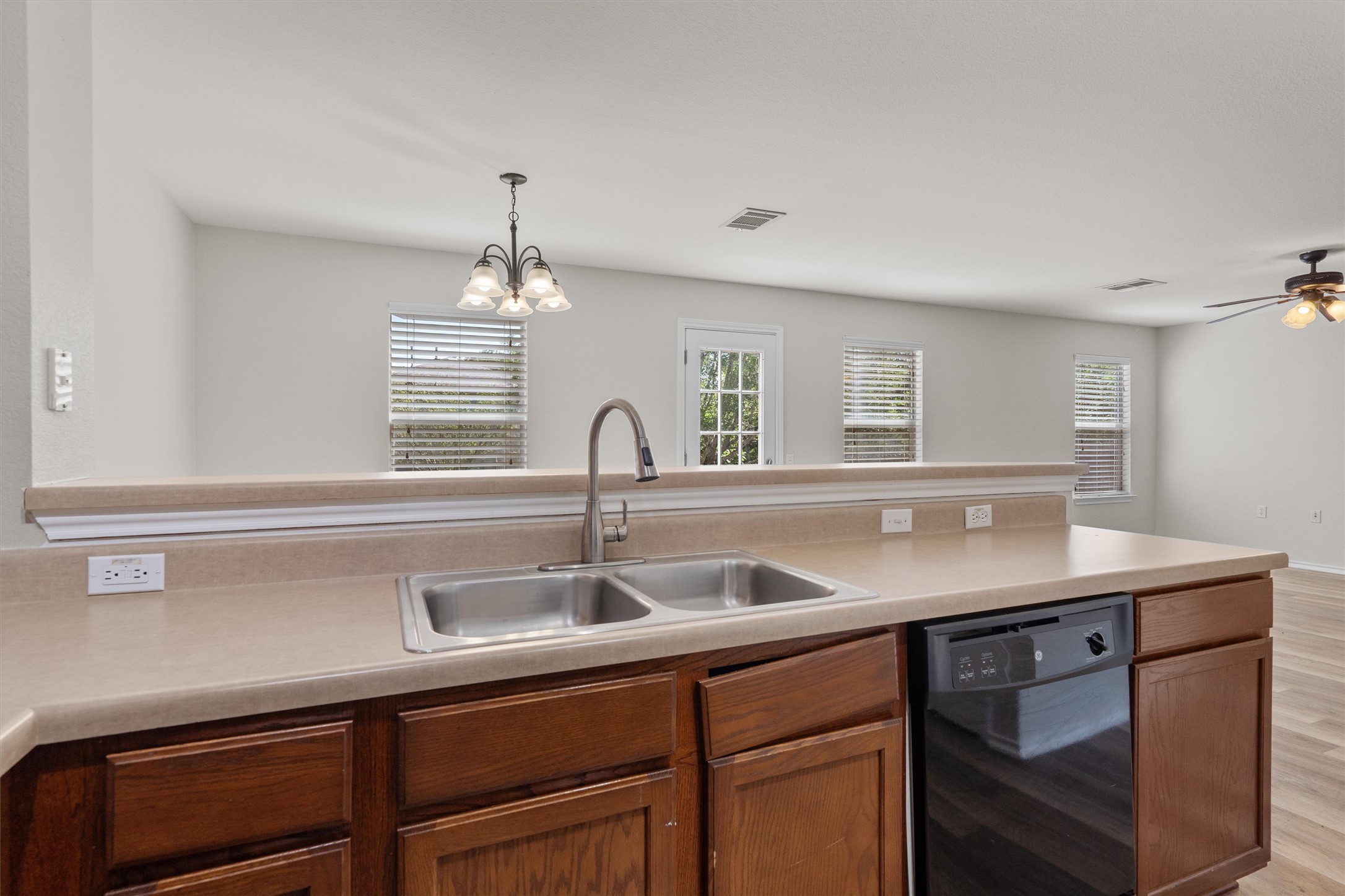 5825 Silver Screen Drive Austin, TX 78747 - Photo 13 of 40 An inviting open-concept kitchen features a stainless steel double sink and ample counter space.