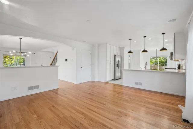 a view of a kitchen with kitchen island and stainless steel appliances