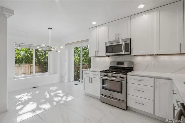 a kitchen with cabinets appliances and a window