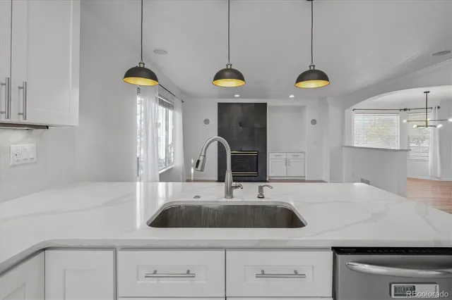 a kitchen with a sink a counter space cabinets and appliances