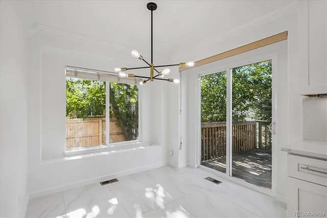 a view of an empty room with a window and ceiling fan
