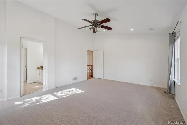 a view of a livingroom with a ceiling fan and window