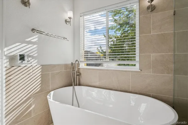 a bathroom with a bathtub and a shower