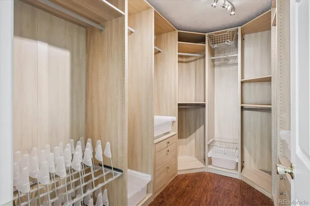 a view of walk in closet with empty racks