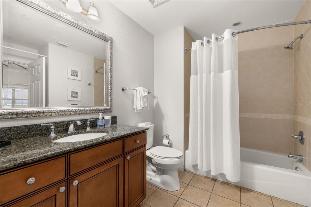 1100 Sunset View Circle, Unit 302 Reunion, FL 34747 - Photo 11 of 56 a bathroom with a double vanity sink toilet mirror and shower