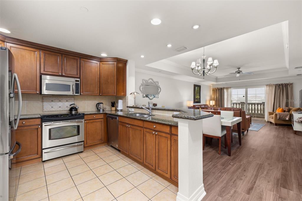 1100 Sunset View Circle, Unit 302 Reunion, FL 34747 - Photo 15 of 56 a large kitchen with cabinets