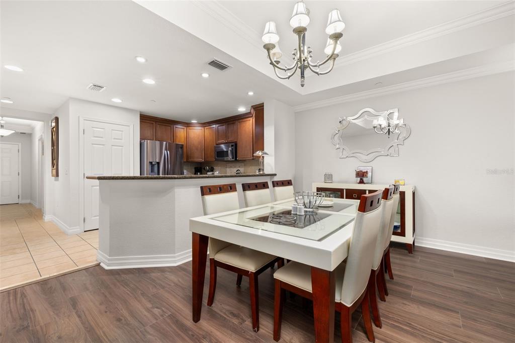1100 Sunset View Circle, Unit 302 Reunion, FL 34747 - Photo 18 of 56 a view of a dining room with furniture wooden floor and chandelier