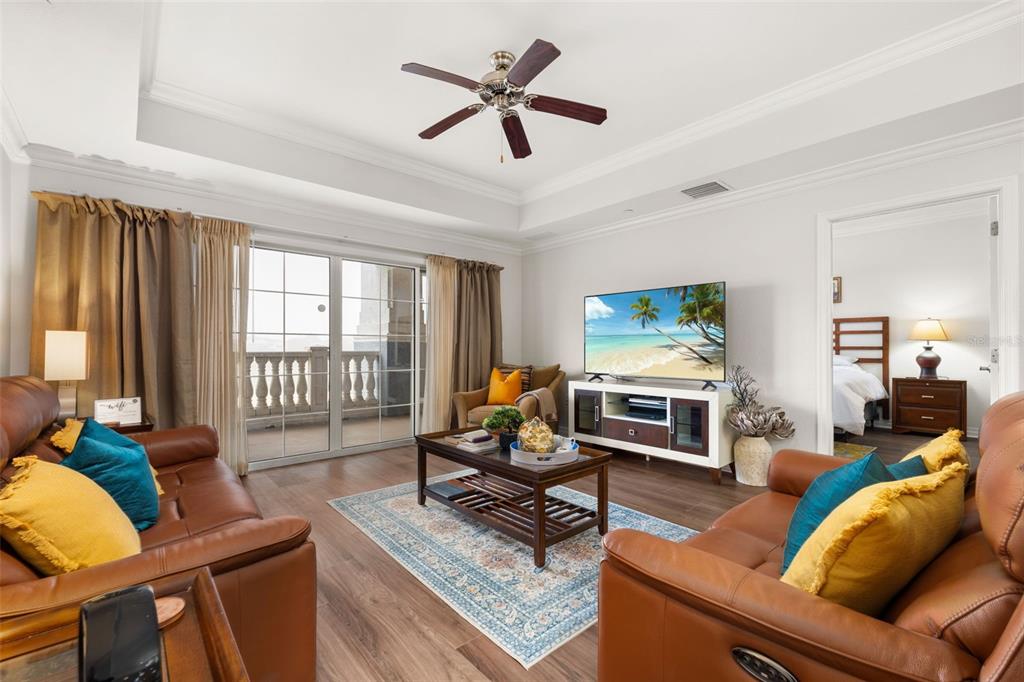 1100 Sunset View Circle, Unit 302 Reunion, FL 34747 - Photo 19 of 56 a living room with furniture a flat screen tv and a large window