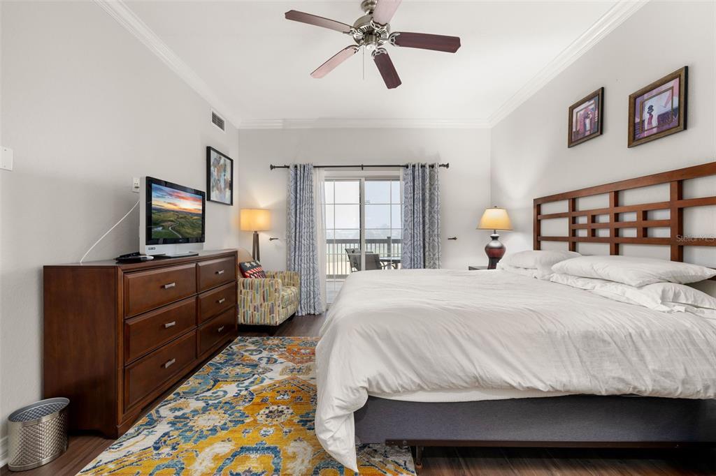 1100 Sunset View Circle, Unit 302 Reunion, FL 34747 - Photo 24 of 56 a bedroom with a bed and a flat screen tv