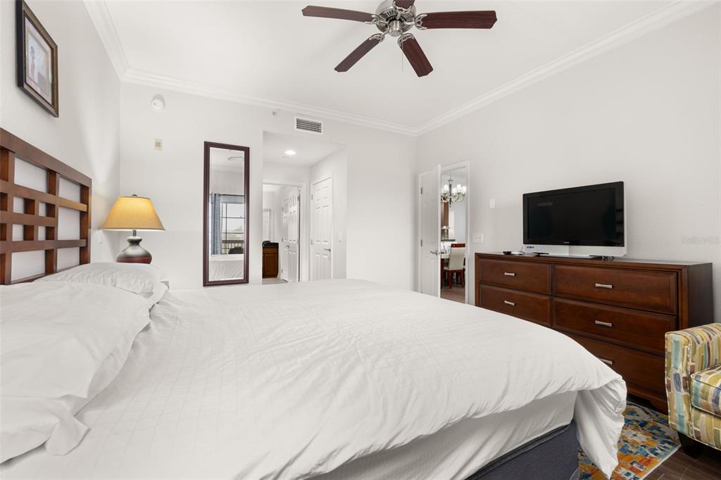 1100 Sunset View Circle, Unit 302 Reunion, FL 34747 - Photo 25 of 56 a bedroom with a bed and a flat screen tv