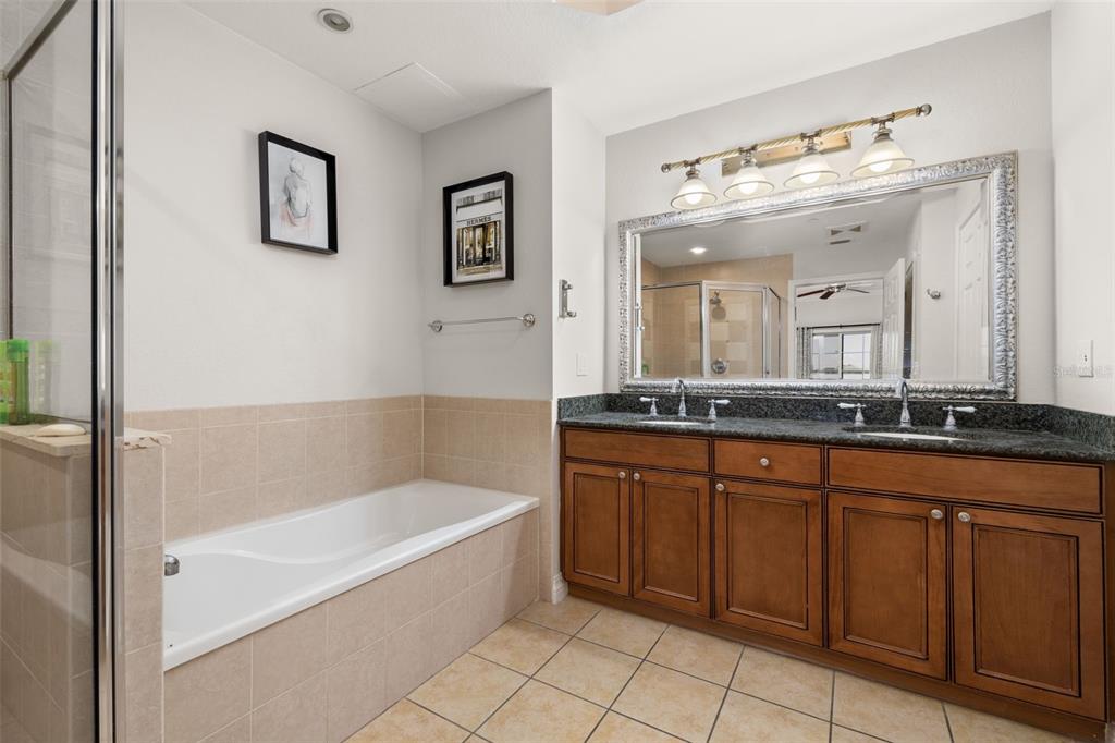 1100 Sunset View Circle, Unit 302 Reunion, FL 34747 - Photo 27 of 56 a spacious bathroom with a tub sink and mirror
