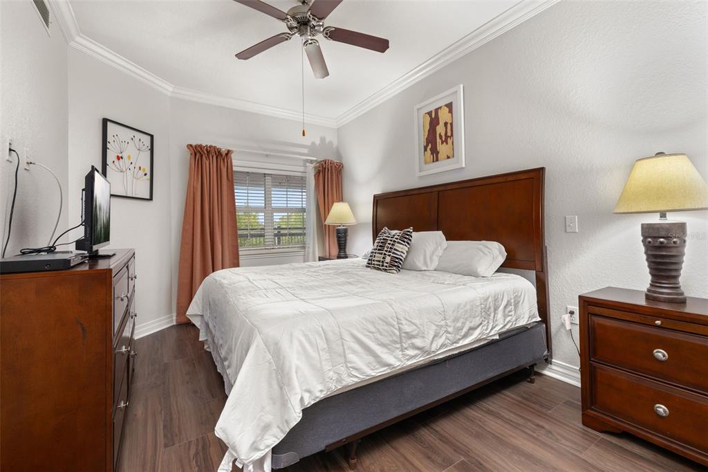 1100 Sunset View Circle, Unit 302 Reunion, FL 34747 - Photo 4 of 56 a bedroom with a bed and wooden floor