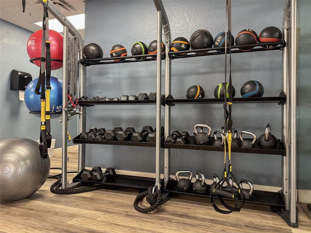 1100 Sunset View Circle, Unit 302 Reunion, FL 34747 - Photo 48 of 56 a room with lots of bottles and chairs