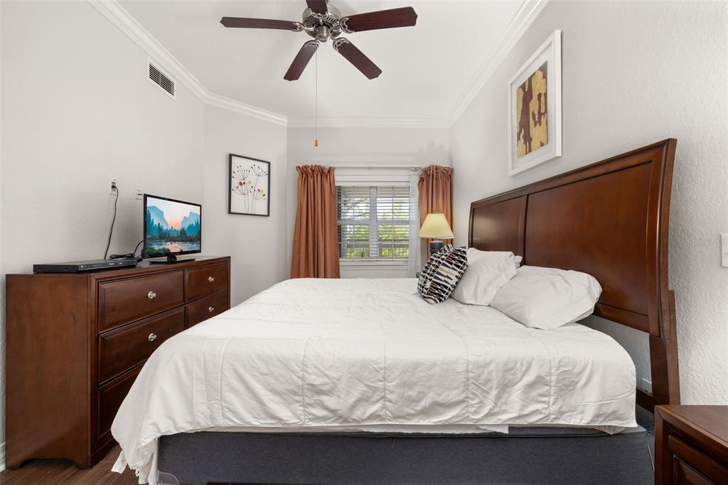 1100 Sunset View Circle, Unit 302 Reunion, FL 34747 - Photo 6 of 56 a bedroom with a bed and wooden floor