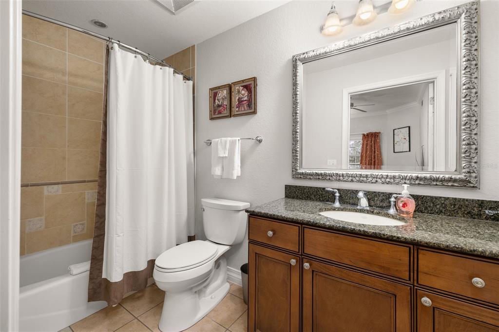 1100 Sunset View Circle, Unit 302 Reunion, FL 34747 - Photo 7 of 56 a bathroom with a granite countertop sink toilet and shower