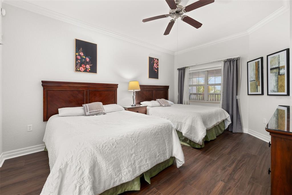 1100 Sunset View Circle, Unit 302 Reunion, FL 34747 - Photo 8 of 56 a bedroom with two beds and painting on the wall