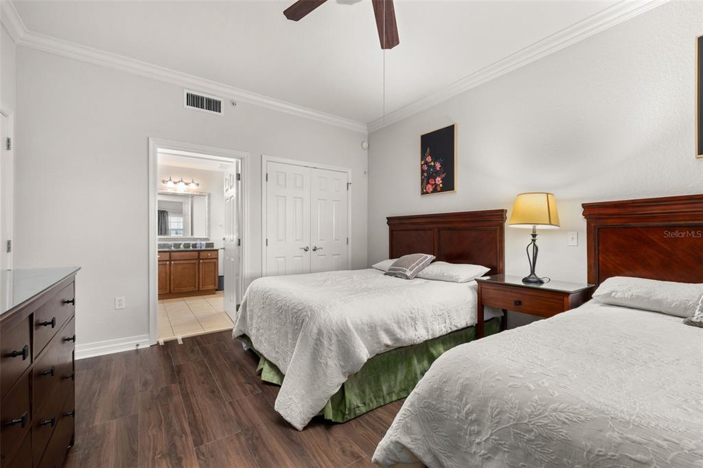 1100 Sunset View Circle, Unit 302 Reunion, FL 34747 - Photo 10 of 56 a bedroom with two beds and painting on the wall