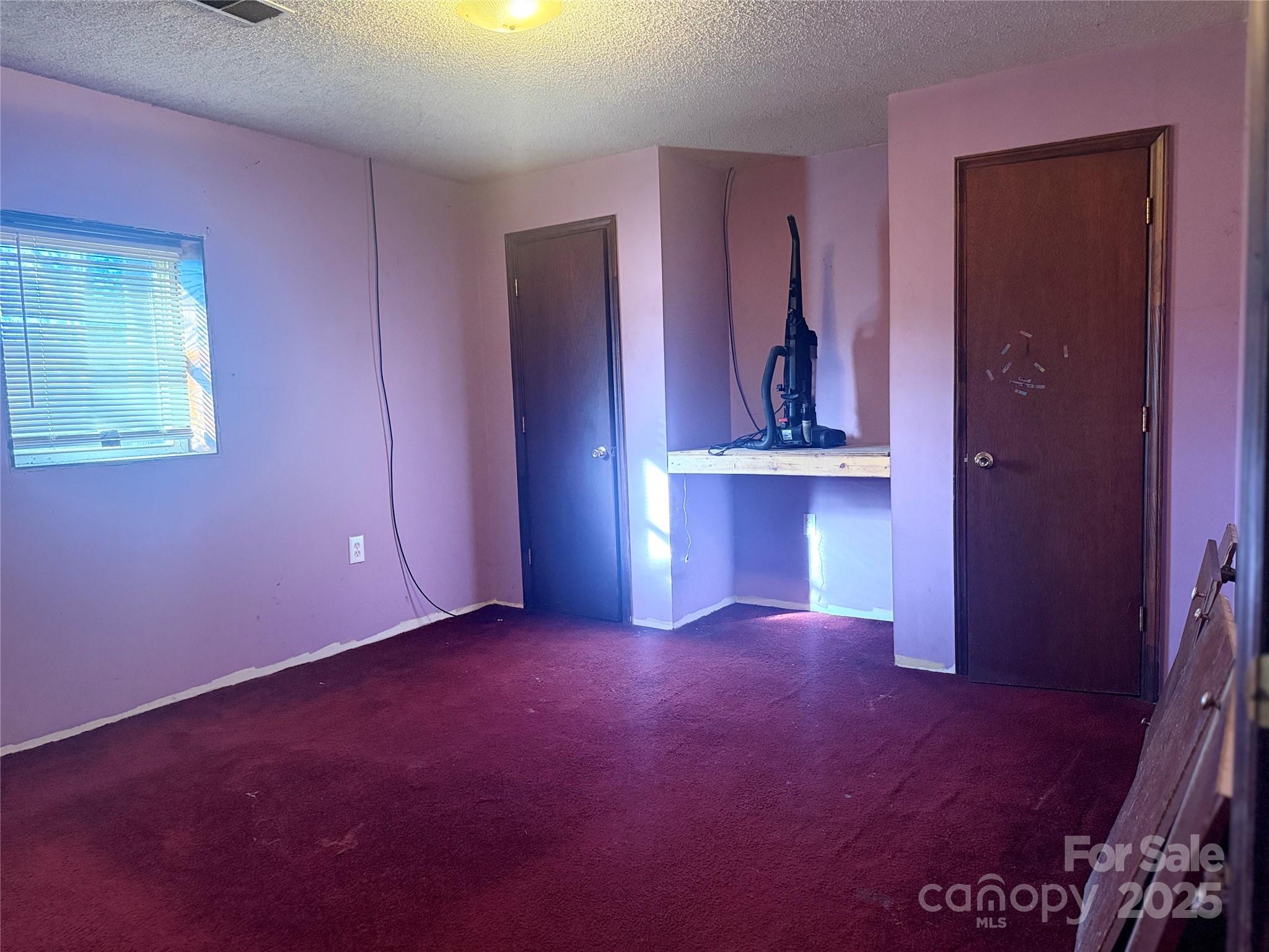 138 Rash Road Lincolnton, NC 28092 - Photo 13 of 41 an empty room with chandelier fan and windows