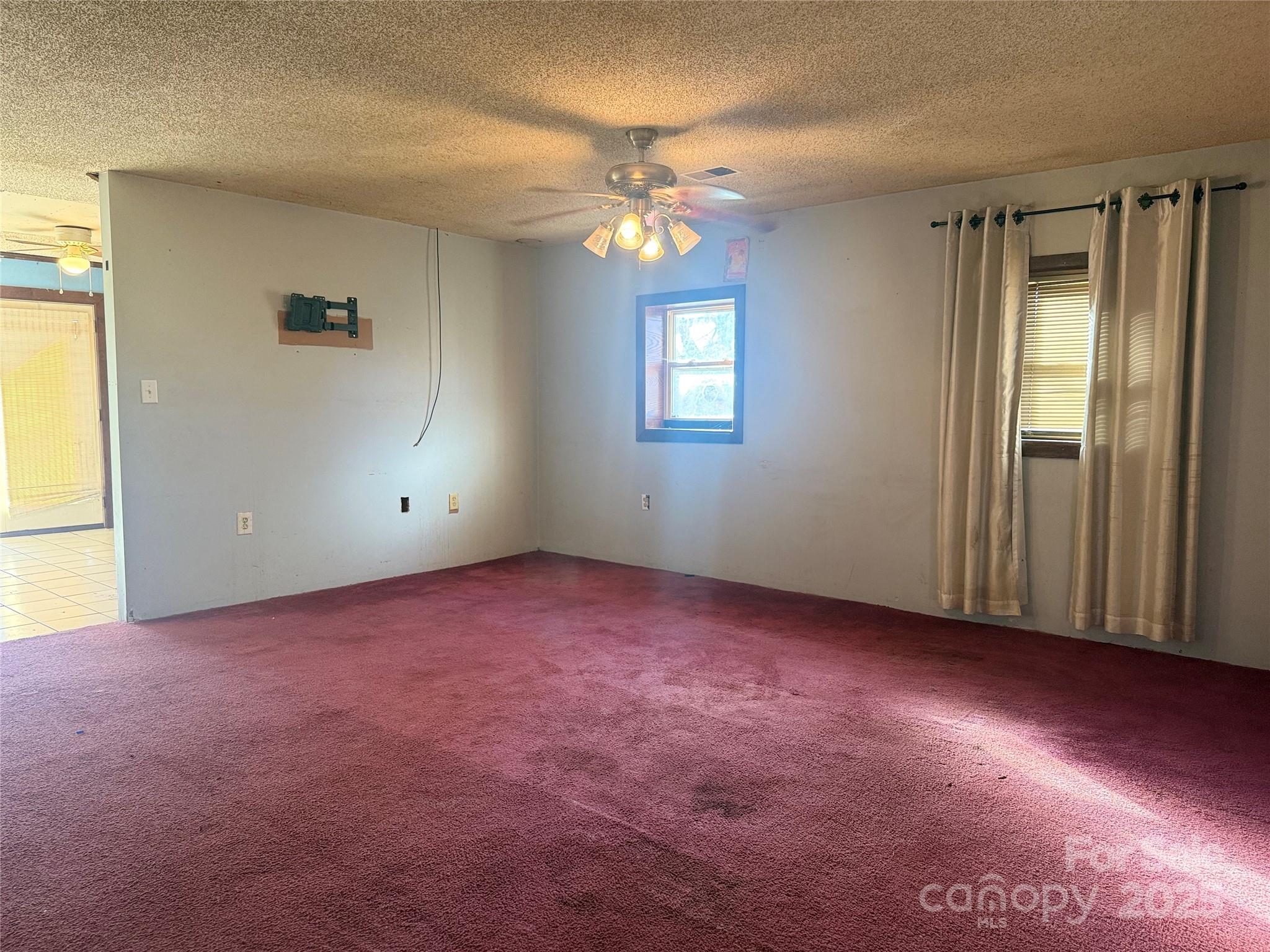 138 Rash Road Lincolnton, NC 28092 - Photo 10 of 41 an empty room with windows and chandelier fan