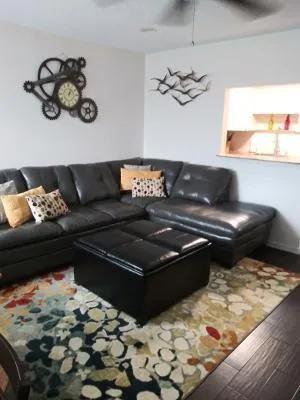 a living room with a couch and a rug