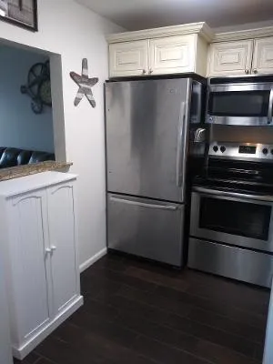 a metallic refrigerator freezer sitting in a kitchen