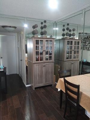 119 Fanshaw C, Unit 119C Boca Raton, FL 33434 - Photo 5 of 10 a view of a dining room with furniture window and wooden floor