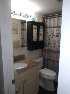 119 Fanshaw C, Unit 119C Boca Raton, FL 33434 - Photo 7 of 10 a bathroom with a sink toilet and shower