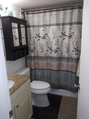 119 Fanshaw C, Unit 119C Boca Raton, FL 33434 - Photo 8 of 10 a bathroom with a toilet and a shower curtain